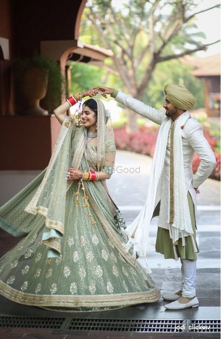 Offbeat bride and groom outfits in seafoam 