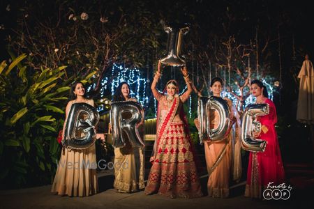 Bride shaped foil balloons shot with bride and her bridesmaids