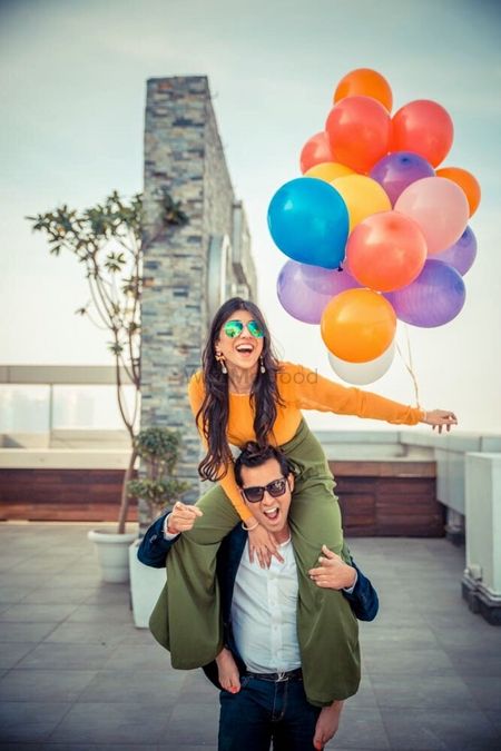 Fun pre wedding shoot with balloons and wife on husbands shoulders