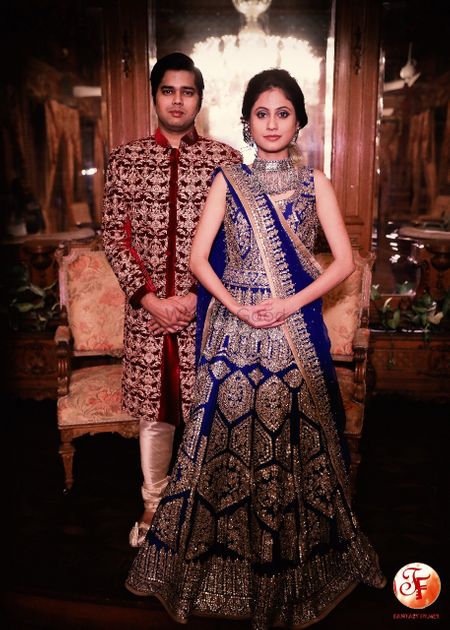Photo of Beautiful royal blue lehenga with work all over and groom in maroon sherwani