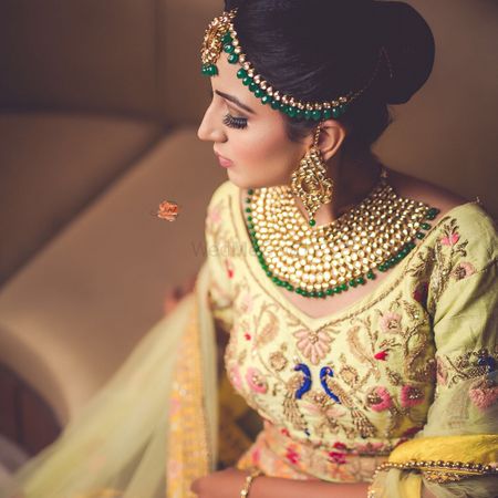  bride in an offbeat yellow lehenga and heavy jewellery