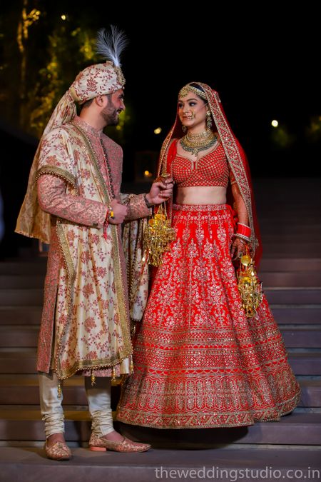 Mismatched bride and groom in floral sherwani 