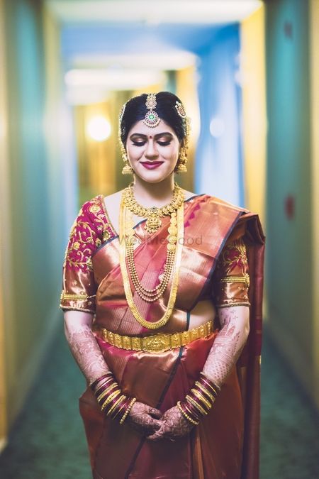 South Indian bride in brown and gold saree 