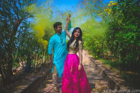 Photo of Colourful pre wedding shoot outdoors with smoke bombs