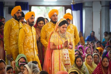 Brothers of the bride wore matching yellow floral jackets with the bride for her wedding day