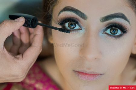 Bride wearing falsies and bold brows 
