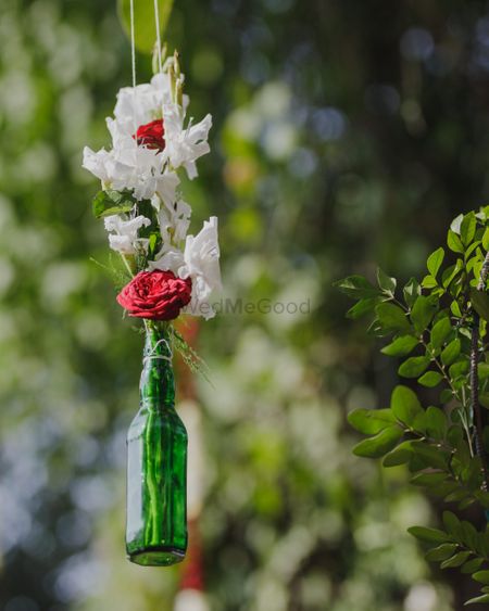 Hanging floral arrangement with beer bottle 