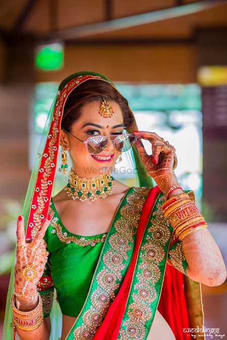 Photo of Cool bride shot in green lehenga wearing sunglasses