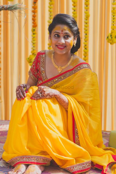 Photo of Beautiful yellow saree with red blouse and gold jewellery