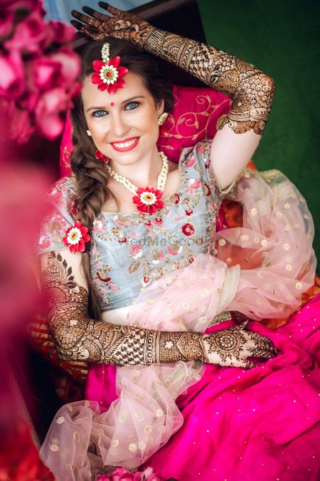 NRI bride in floral jewellery on mehendi 