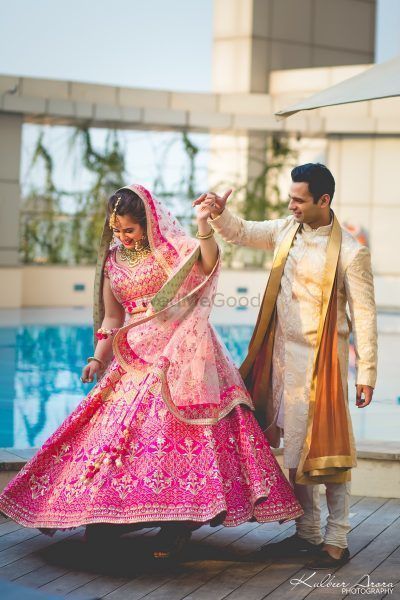 Couple shot with bride in pink ombre lehenga 