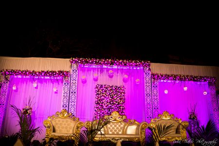 Photo of purple and gold stage decor
