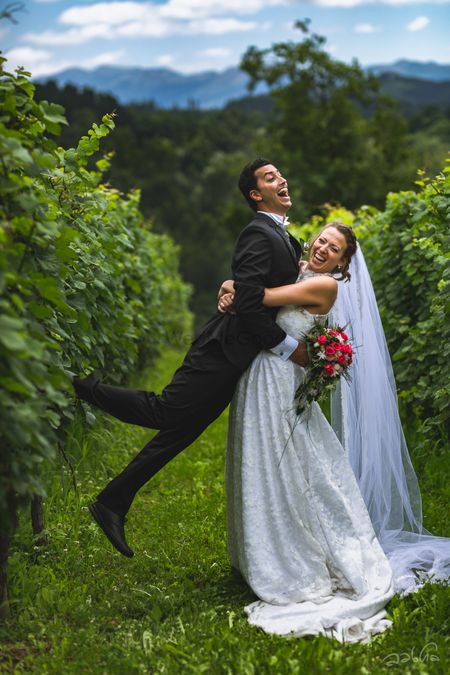Amazing vinyard white wedding with a fun couple portrait