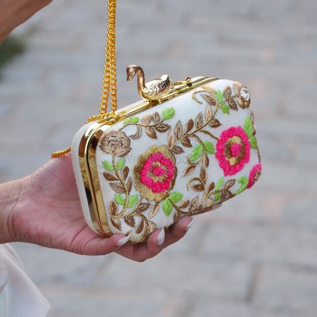 white pink and green clutch