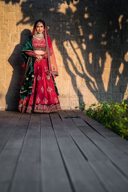 Wedding day bridal shot in red and green lehenga 