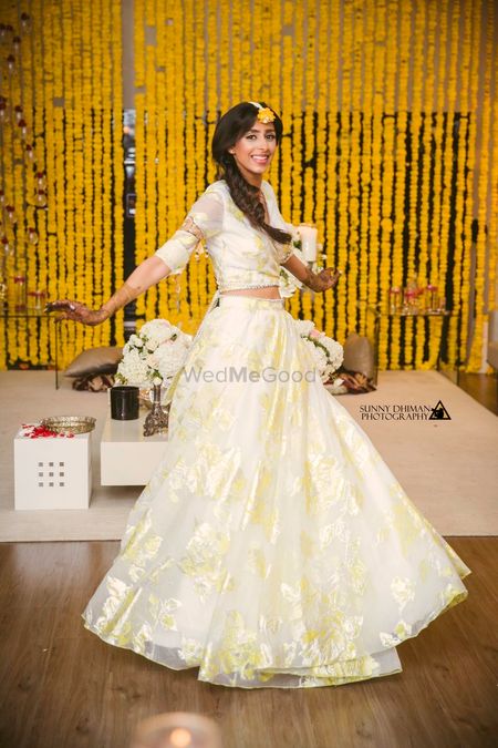 Photo of Bride twirling in simple off white organza lehenga