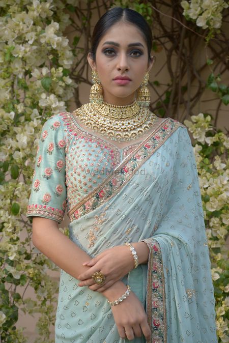 Stunning pastel saree in powder blue and bridal jewellery