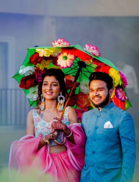Photo of Unique couple entry with floral umbrella