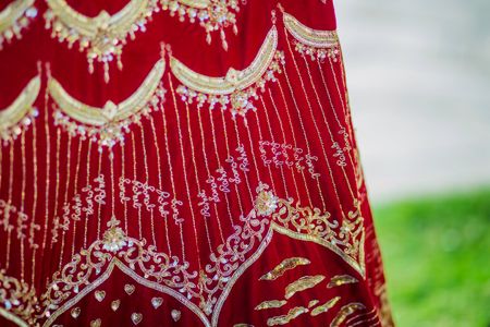 Photo of Personalised bridal lehenga in red with couples names