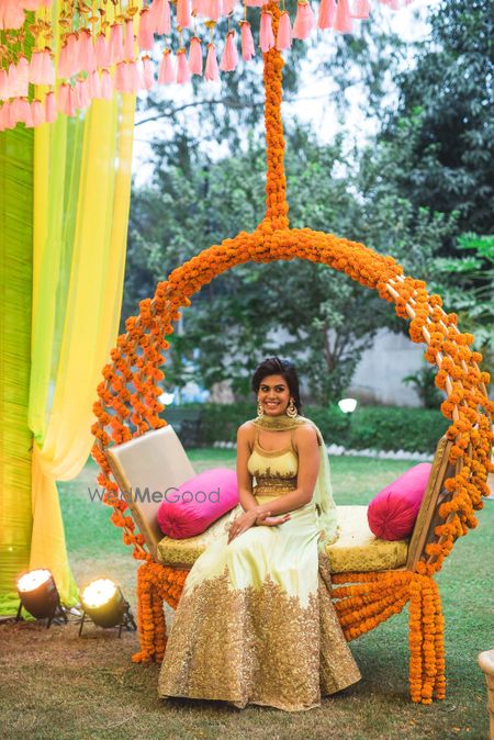 Mehendi bridal seat decor with genda phool