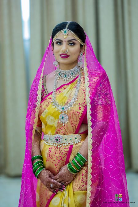South Indian bride in yellow saree and diamond jewellery 