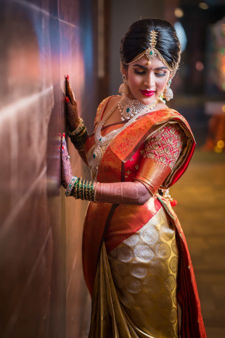 South Indian bridal look in gold kanjivaram with orange 