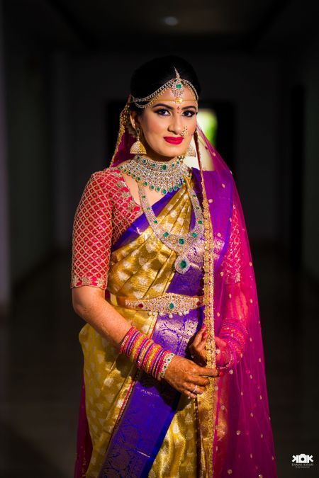 South indian bride in contrasting kanjivaram saree