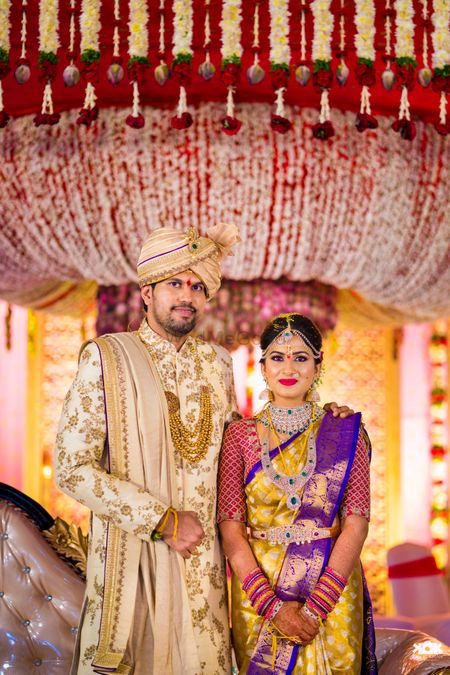 South indian couple shot with floral decor backdrop