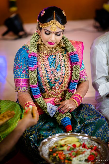 south indian bride in vibrant saree combination