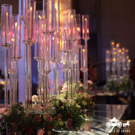Photo of Gorgeous set up for a table setting with tall glasses and floral arrangements