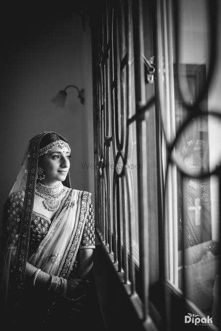 Bride looking out of window black and white shot 