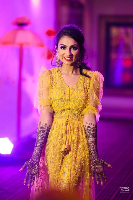 bridal portrait in yellow outfit on her mehendi