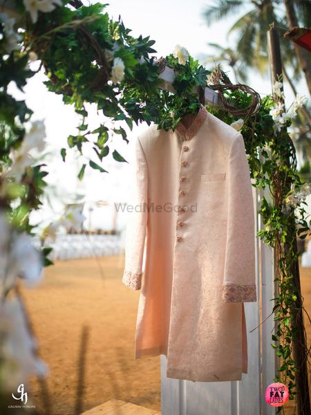 Photo of Light pink or peach sherwani on hanger