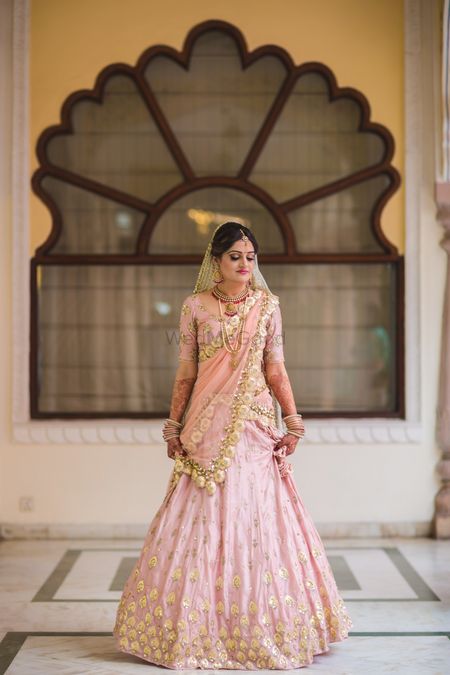 Photo of Light pink and gold pastel bridal lehenga
