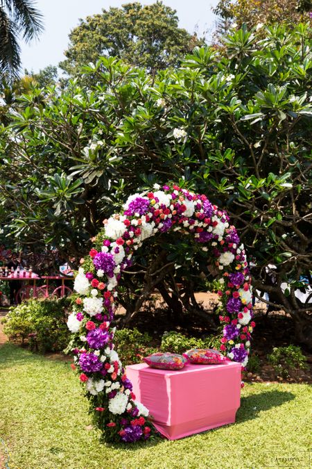 Floral wreath seating for a bride on a mehendi function