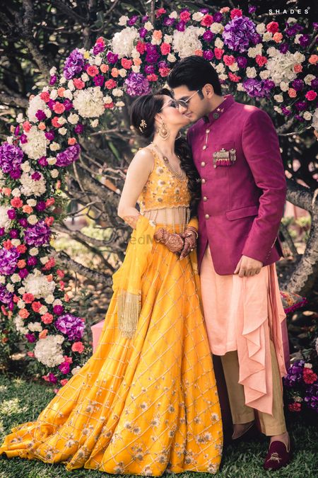Photo of Bride and groom mehendi portrait in unique outfits