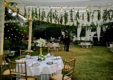 Beautiful white tents with greenery and white decor