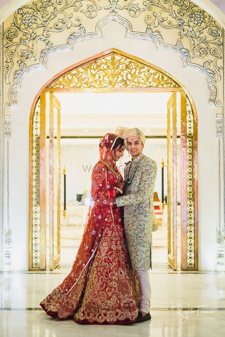 Bride and groom in contrasting embroidered outfits 