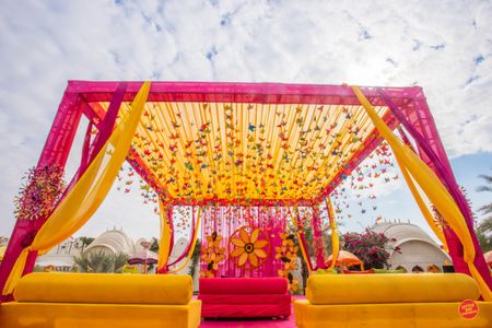 Mehendi tent decor idea in yellow and pink 