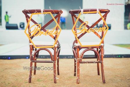 Bride and groom chair decor idea with signs 