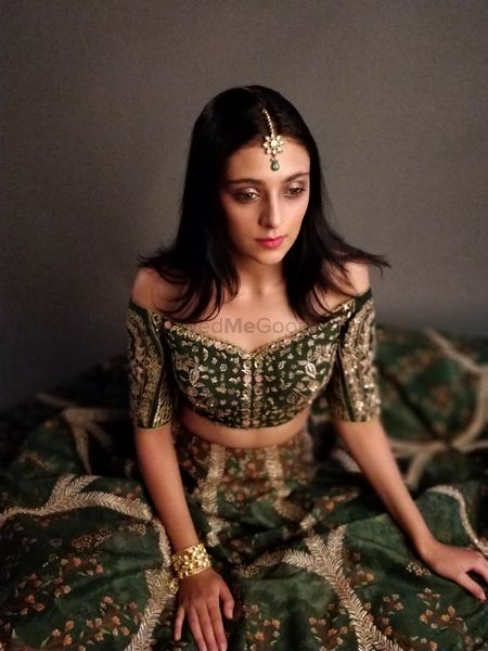 Off shoulder forest green lehenga for the sister of the bride or groom