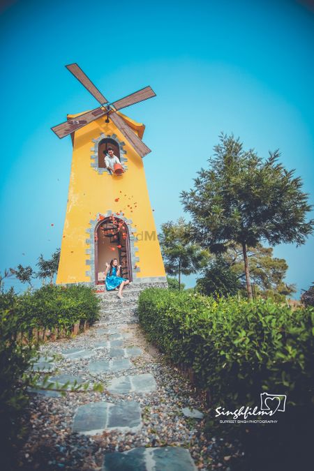 Photo of Pretty outdoor pre wedding function with a windmill