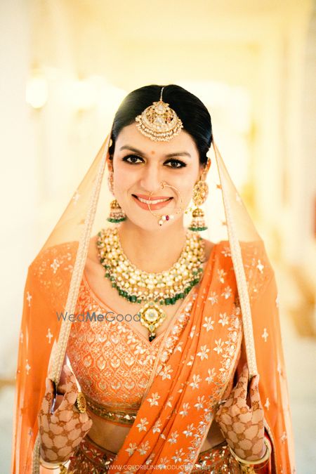 Stunning bridal portrait with emerald jewellery and gotapatti lehenga