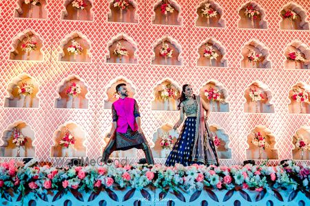 Couple dancing on stage on sangeet