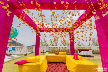 Mehendi seating decor idea in pink and yellow 