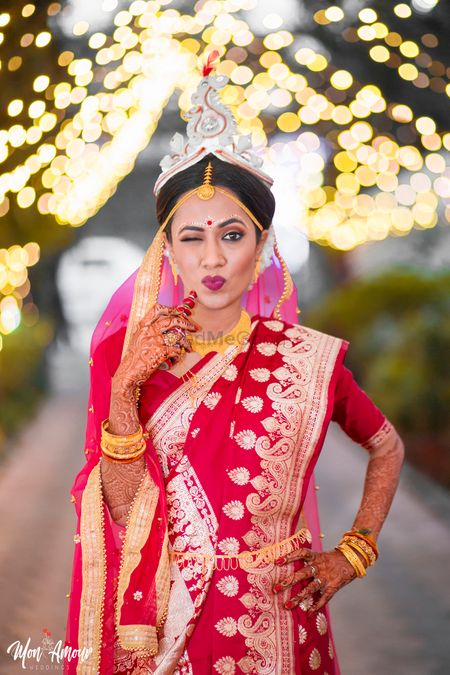 Pretty bengali bride in traditional makeup and red saree