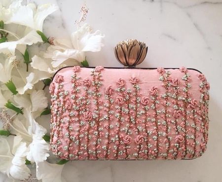 Stunning baby pink clutch with floral work and a lotus motif lock