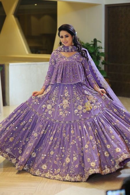 Pretty lavendar lehenga with floral motifs and long top 