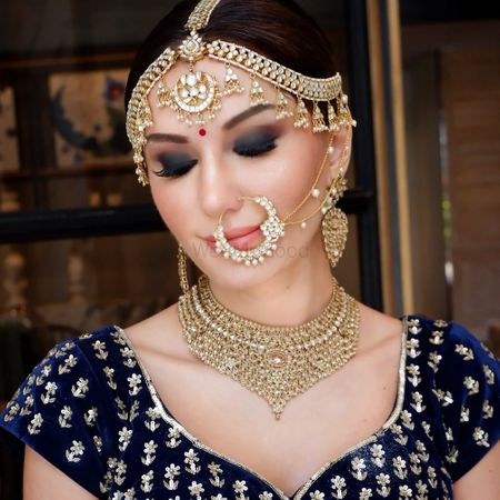 Photo of Gorgeous gold bridal jewellery with royal blue blouse