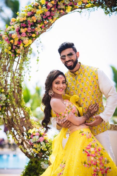 Mehendi bride and groom look in yellow outfits 